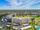 Aerial view of condo and surrounding mature landscaping, golf course and other buildings at 3680 Ironwood Circle # 704-L, Bradenton, FL 34209