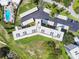 Aerial view of building showcasing roof, landscaping, nearby golf course, and swimming pool at 3680 Ironwood Circle # 704-L, Bradenton, FL 34209