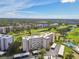 Aerial view of condo community with golf course, swimming pool, and mature trees at 3680 Ironwood Circle # 704-L, Bradenton, FL 34209
