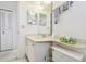 Well-lit, functional bathroom with a white vanity and a mirrored wall offers everyday convenience at 3680 Ironwood Circle # 704-L, Bradenton, FL 34209