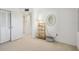 Bright, open bedroom features an open closet and a decorative mirror with a lamp at 3680 Ironwood Circle # 704-L, Bradenton, FL 34209
