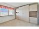 Bright bedroom features a large window and ample built-in storage with light-colored wooden cabinets at 3680 Ironwood Circle # 704-L, Bradenton, FL 34209