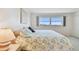 Bright bedroom featuring a cozy bed and large window at 3680 Ironwood Circle # 704-L, Bradenton, FL 34209