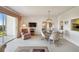 Dining area featuring a glass table, comfortable chairs, and a view of the screened balcony at 3680 Ironwood Circle # 704-L, Bradenton, FL 34209