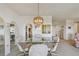 Dining room featuring a glass table with chairs and an elegant chandelier at 3680 Ironwood Circle # 704-L, Bradenton, FL 34209