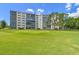Exterior of building surrounded by a lush lawn and mature trees at 3680 Ironwood Circle # 704-L, Bradenton, FL 34209