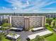 Exterior shot of building with balconies and covered parking on a sunny day at 3680 Ironwood Circle # 704-L, Bradenton, FL 34209