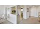 Hallway featuring arched entryway, neutral tones, and partial views of the kitchen and front door at 3680 Ironwood Circle # 704-L, Bradenton, FL 34209
