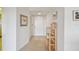 Hallway with neutral walls, tile floor, art and a storage rack at 3680 Ironwood Circle # 704-L, Bradenton, FL 34209