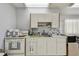 Full kitchen with white cabinetry, countertops, a double basin sink, and standard appliances at 3680 Ironwood Circle # 704-L, Bradenton, FL 34209