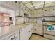 Functional kitchen with ample cabinetry, white appliances, and adjacent dining area at 3680 Ironwood Circle # 704-L, Bradenton, FL 34209
