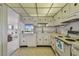 Well-lit kitchen with neutral countertops and vintage appliances, open to the living area at 3680 Ironwood Circle # 704-L, Bradenton, FL 34209