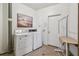 Functional laundry room with washer, dryer, and a utility sink, combining practicality with convenience at 3680 Ironwood Circle # 704-L, Bradenton, FL 34209