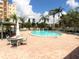 Outdoor community pool surrounded by ample lounging space and lush greenery at 3680 Ironwood Circle # 704-L, Bradenton, FL 34209