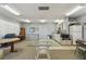 Open recreation room with laminate flooring, an adjacent kitchen, tables, and many chairs at 3680 Ironwood Circle # 704-L, Bradenton, FL 34209