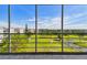 Screened-in balcony offering expansive views of the golf course and surrounding landscape at 3680 Ironwood Circle # 704-L, Bradenton, FL 34209