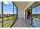 Balcony view into living space showing golf course and pond at 3680 Ironwood Circle # 704-L, Bradenton, FL 34209