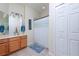 Bathroom with a double sink vanity, a large mirror, and a shower with curtain at 3698 Parkridge Cir # 26-104, Sarasota, FL 34243