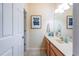 Bathroom featuring a wooden vanity, tile floors, and a mirror with modern lighting at 3698 Parkridge Cir # 26-104, Sarasota, FL 34243