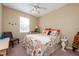 Colorful bedroom with coastal decor, a side table, and a ceiling fan at 3698 Parkridge Cir # 26-104, Sarasota, FL 34243