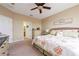 Cozy bedroom with ceiling fan, ensuite bathroom, neutral walls, and wicker headboard at 3698 Parkridge Cir # 26-104, Sarasota, FL 34243