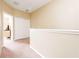 Upstairs hallway with carpet, closet, and neutral walls leading to other rooms at 3698 Parkridge Cir # 26-104, Sarasota, FL 34243