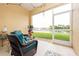 Screened patio featuring wicker furniture and a view of the lake at 3698 Parkridge Cir # 26-104, Sarasota, FL 34243