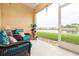 Screened patio featuring wicker furniture and a view of the lake at 3698 Parkridge Cir # 26-104, Sarasota, FL 34243