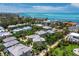 Aerial view of a beautiful coastal community with waterfront homes nestled amidst lush greenery and stunning ocean views at 3959 Somerset Dr # 5, Sarasota, FL 34242