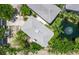 Aerial shot features property roof, lush greenery, and serene pond with fountain, highlighting privacy at 3959 Somerset Dr # 5, Sarasota, FL 34242