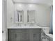 Bathroom with double vanity, framed mirrors, and designer fixtures at 3959 Somerset Dr # 5, Sarasota, FL 34242