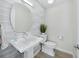 Stylish powder room features modern fixtures, decorative textured tile wall and a sleek pedestal sink at 3959 Somerset Dr # 5, Sarasota, FL 34242