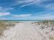 Picturesque beach scene with white sand, clear turquoise water, and beach umbrellas for a serene getaway at 3959 Somerset Dr # 5, Sarasota, FL 34242