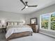 Bright bedroom features a large window, ceiling fan, bed and dresser at 3959 Somerset Dr # 5, Sarasota, FL 34242