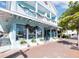 Charming two-story building with a blue exterior and festive holiday decorations on the balconies and windows at 3959 Somerset Dr # 5, Sarasota, FL 34242