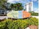 Sign for Siesta Key Village surrounded by greenery, in front of a modern building on a clear day at 3959 Somerset Dr # 5, Sarasota, FL 34242