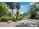 Circular driveway lined with lush landscaping leads to beautiful homes in a tropical community at 3959 Somerset Dr # 5, Sarasota, FL 34242