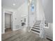 Bright foyer with stairs leading to the second level, views to kitchen, and entrance to powder room at 3959 Somerset Dr # 5, Sarasota, FL 34242