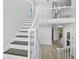 Bright open staircase with entry to other rooms, light neutral color palette, and wood flooring at 3959 Somerset Dr # 5, Sarasota, FL 34242