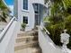 Inviting front entrance with tiled steps, white railings, and lush tropical landscaping at 3959 Somerset Dr # 5, Sarasota, FL 34242