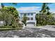 Charming two-story home with a light blue exterior, lush landscaping, and a well-maintained front yard at 3959 Somerset Dr # 5, Sarasota, FL 34242