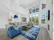 Airy living room featuring soaring ceilings, fireplace, and large windows at 3959 Somerset Dr # 5, Sarasota, FL 34242