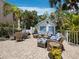 Inviting outdoor patio features stylish seating, brick pavers, and ambient string lights for relaxed evenings at 3959 Somerset Dr # 5, Sarasota, FL 34242