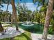 Scenic pond with a fountain feature, surrounded by lush greenery and white pebble accents at 3959 Somerset Dr # 5, Sarasota, FL 34242
