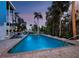 Beautiful in-ground pool with surrounding deck and tropical landscaping, perfect for outdoor enjoyment and relaxation at 3959 Somerset Dr # 5, Sarasota, FL 34242