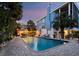 Charming pool area at dusk with outdoor dining, creating a serene and inviting atmosphere for entertaining at 3959 Somerset Dr # 5, Sarasota, FL 34242