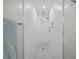 Walk-in shower with textured white tile walls, hexagon tile floor, and dual shower heads at 3959 Somerset Dr # 5, Sarasota, FL 34242
