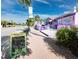 Vibrant street scene featuring colorful buildings, palm trees, and a sign for local brewery's happy hour at 3959 Somerset Dr # 5, Sarasota, FL 34242