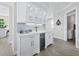 Elegant bar area with custom cabinetry, wine cooler, and decorative lighting at 3959 Somerset Dr, Sarasota, FL 34242