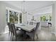 Dining area with bright natural light and neutral colors, leads to modern kitchen at 3959 Somerset Dr, Sarasota, FL 34242